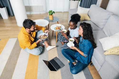 Boston roommates sitting in furnished coliving apartment